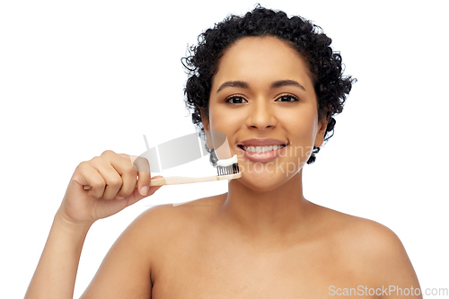 Image of smiling woman with toothbrush cleaning teeth