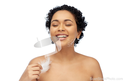 Image of happy african american woman with feather