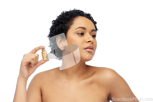 Image of african american woman with gold mask in bottle