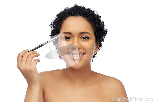 Image of african american woman with make up brush