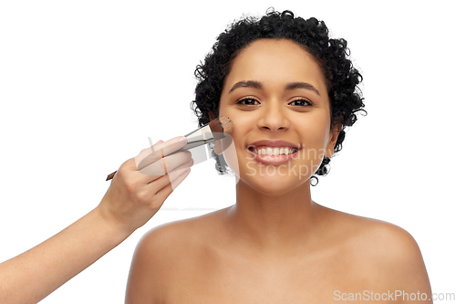 Image of happy woman and hand of make up artist with brush