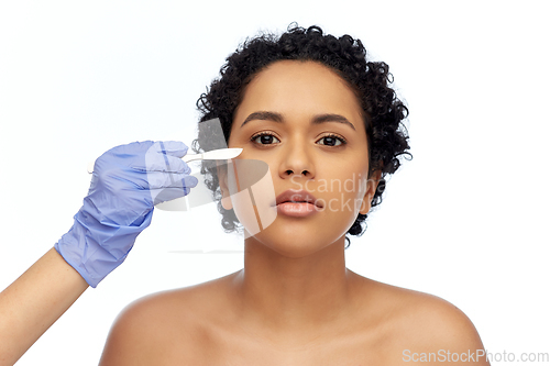 Image of african american woman and hand with scalpel knife