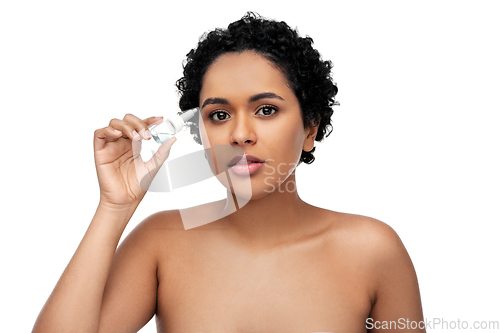 Image of young african american woman with eye drops