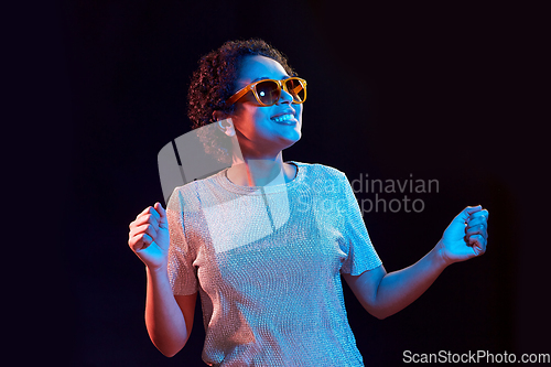 Image of african american woman dancing over neon lights