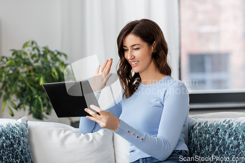 Image of woman having video call on tablet pc at home