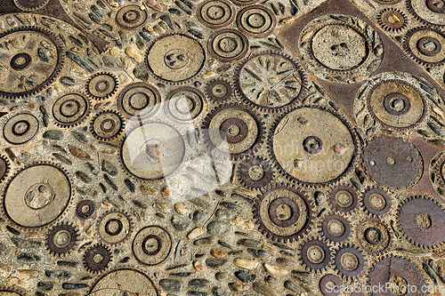 Image of Unusual floor with pattern from pebbles and rusty metal details