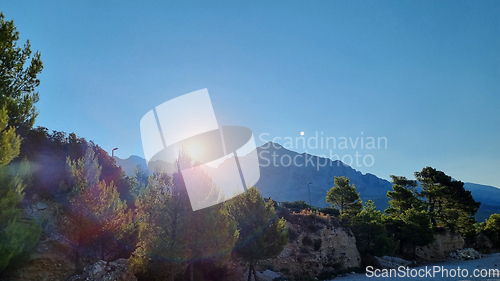 Image of Sunrise over Biokovo Mountain Nature park and trees from Makarska Riviera-Biokovo