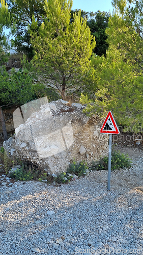 Image of Attention sign for rock fall. Attention sign Falling rocks. Biokovo Mountain Nature park and trees from Makarska Riviera-Biokovo, Dalmatia, Croatia, Europe