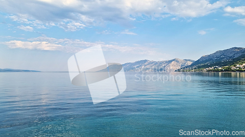 Image of Beautiful shore of the Adriatic Sea. Bay view with cloudscape. Sunrise