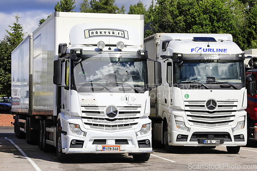 Image of Two White Mercedes-Benz Actros Freight Trucks Parked