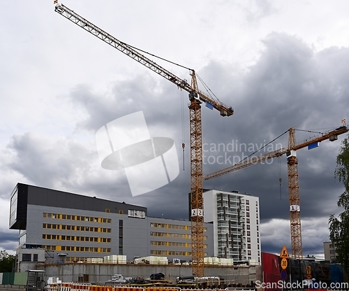 Image of two cranes at the construction site 