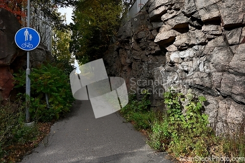 Image of walking and cycling path next to a rock in Finland