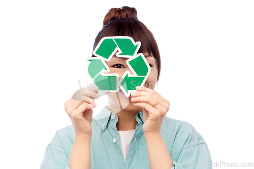 Image of smiling asian woman holding green recycling sign