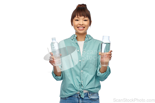 Image of asian woman with plastic and glass bottle of water