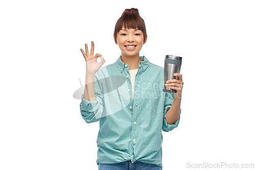 Image of woman with thermo cup or tumbler showing ok sign