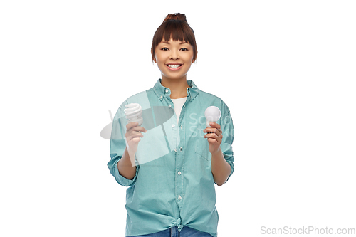 Image of asian woman holding energy saving lighting bulb