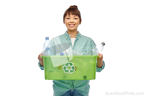 Image of smiling young asian woman sorting plastic waste