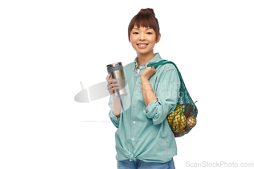 Image of woman with thermo cup or tumbler for hot drinks