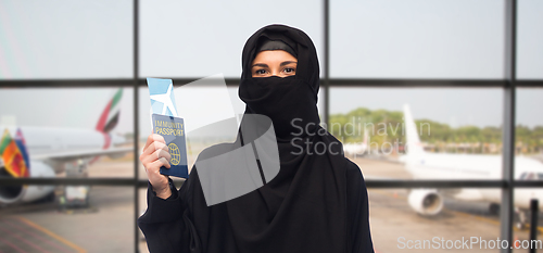 Image of muslim woman with air ticket and immunity passport