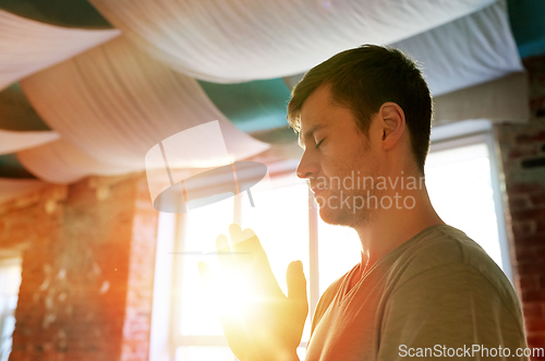 Image of close up of man meditating at yoga studio