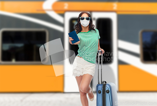 Image of teenage girl in mask with travel bag and passport
