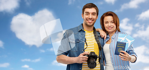 Image of couple with tickets, immunity passport and camera