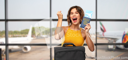 Image of happy woman with air ticket and immunity passport