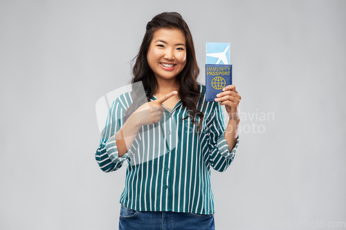 Image of asian woman with air ticket and immunity passport