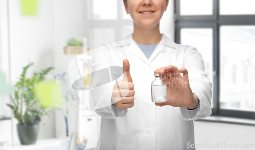 Image of doctor with medicine showing thumbs up at hospital