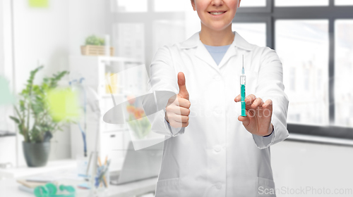 Image of doctor with syringe showing thumbs up at hospital