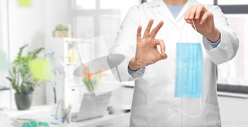 Image of doctor with medical mask showing ok at hospital