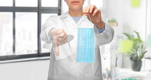Image of doctor with mask showing thumbs down at hospital