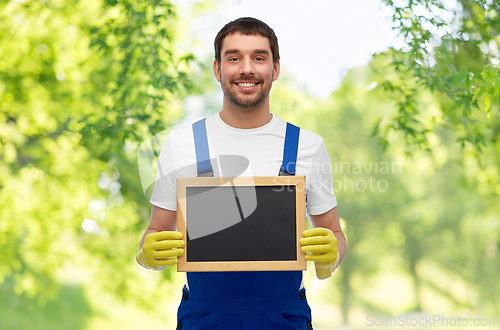 Image of smiling worker or male cleaner showing chalkboard