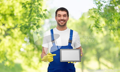 Image of happy male worker or cleaner showing tablet pc