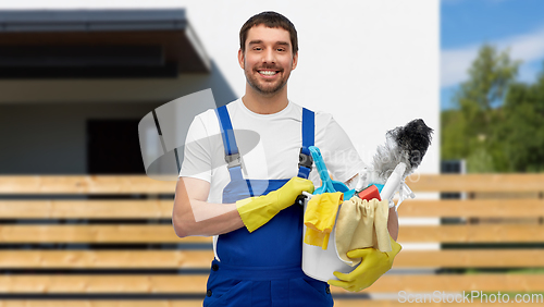 Image of male cleaner in overall with cleaning supplies