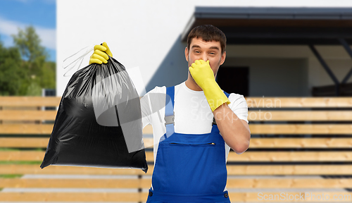 Image of male worker or cleaner with stinky garbage bag