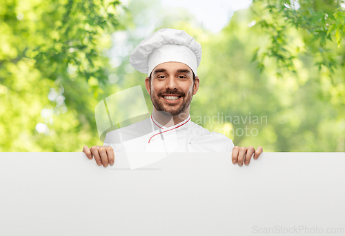 Image of happy smiling male chef with big white board