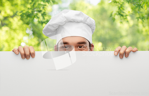 Image of male chef hiding behind big white board