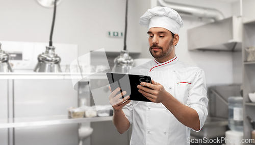 Image of male chef with tablet pc at kitchen