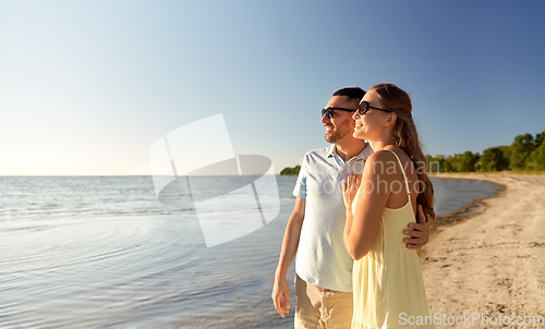 Image of happy couple hugging on summer beach