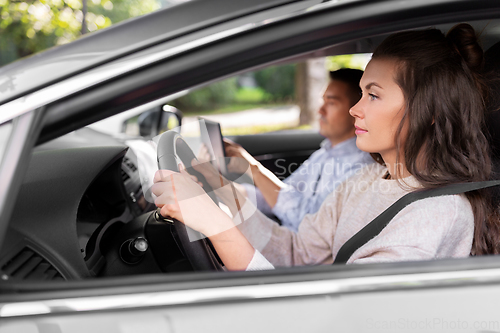 Image of car driving school instructor teaching woman