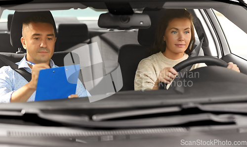 Image of car driving school instructor and young driver