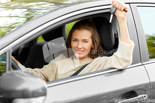 Image of woman or female driver with car key in city