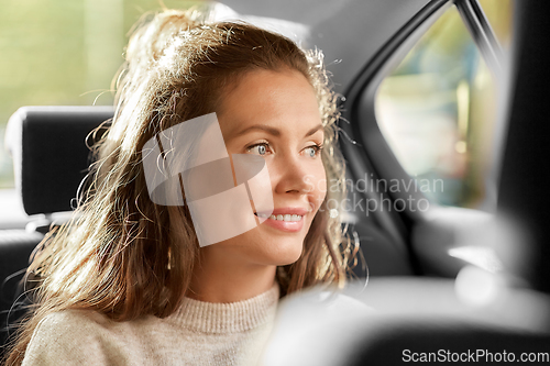 Image of happy smiling woman or female passenger in car