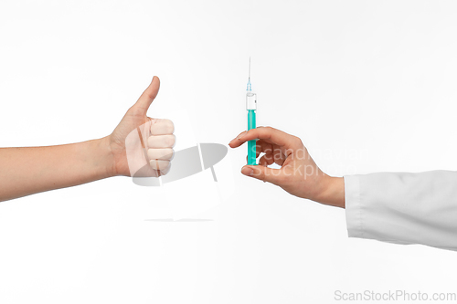 Image of hand with medicine and showing thumbs up