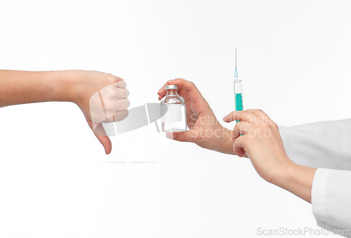 Image of hand with medicine and showing thumbs down