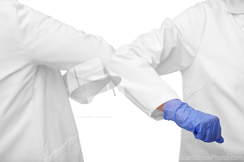 Image of close up of doctors make elbow bump gesture