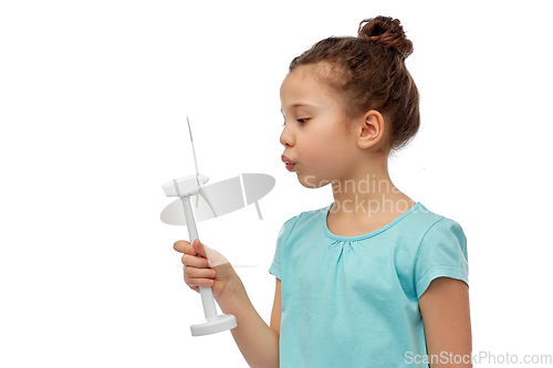 Image of smiling girl with toy wind turbine