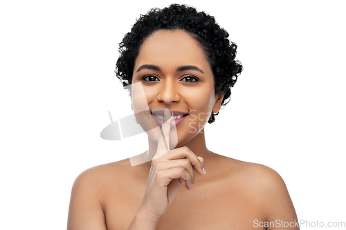 Image of young african american woman with finger on lips