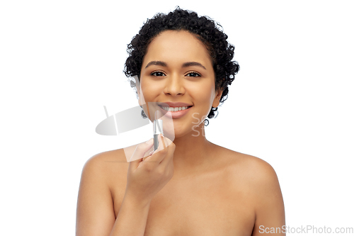 Image of african american woman applying lipstick